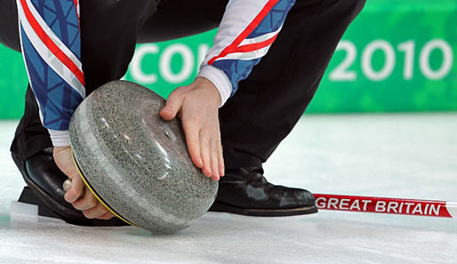 Curling: Ewan MacDonald vom Team Großbritannien streicht zärtlich sein Sportgerät sauber. Mit Erfolg: 9:4-Sieg gegen China!