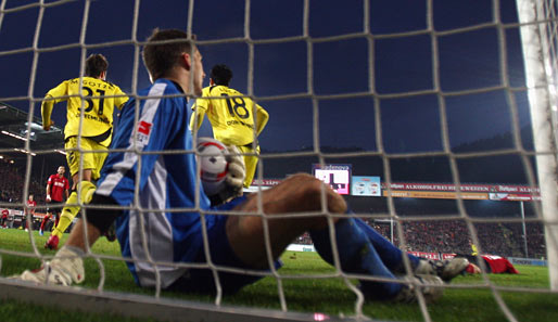 Oliver Baumann sitzt mit dem Ball nach dem entscheidenden Eigentor in seinem Gehäuse und genießt den Freiburger Nachthimmel