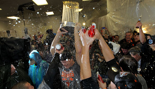 Matt Cain von den San Francisco Giants hält stolz den Pokal der MLB-World-Series in seinen Händen. Die Bierdusche darf dabei nicht fehlen