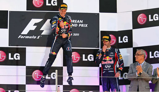 Kein Vettel-Finger, aber ein altbekannter Schumi-Sprung! Der Weltmeister feiert seinen Sieg. Mark Webber scheint nicht ganz so fröhlich