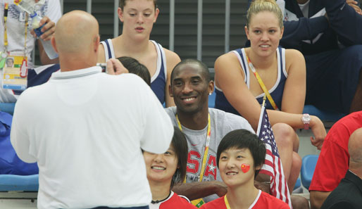 Basketball-Star Kobe Bryant vertreibt sich die Wartezeit am Beckenrand mit den Fans