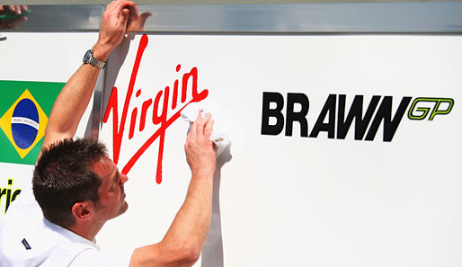 Emsig wurden bei Brawn GP die Sponsor-Aufkleber von Virgin angebracht