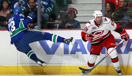 NHL: Alexander Edler von den Vancouver Canucks (l.) prallt wie ein Flummi von Carolinas Chad LaRose ab. Dennoch siegten die Canucks am Ende mit 5:1