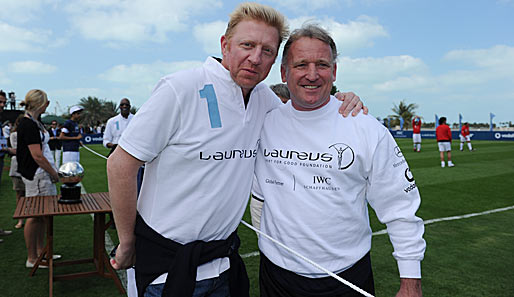 Bei bestem Wetter grinsen Boris Becker und Andreas Brehme (r.), Fußball-Weltmeister von 1990, um die Wette