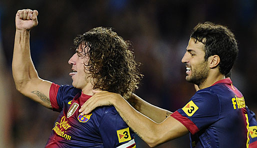 Carles Puyol (l.) bleibt bis 2016 beim FC Barcelona