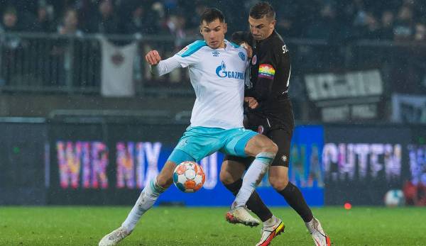 Schalkes Stürmer Marvin Pieringer versucht, unter Druck des St. Pauli Kapitäns Philipp Ziereis den Ball zu behaupten.