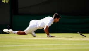 LONDON, ENGLAND - JULY 02: Novak Djokovic of Serbia slips during the Men's Singles third round match against Sam Querrey of The United States on day six of the Wimbledon Lawn Tennis Championships at the All England Lawn Tennis and Croquet Club on Ju...