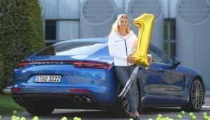 MUNICH, GERMANY - SEPTEMBER 13: Angelique Kerber of Germany poses in front of a new Porsche Panamera Turbo after returning as new Tennis World number One and winner of the US Open at Munich Airport on September 13, 2016 in Munich, Germany. (Photo ...
